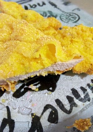 Una foto de Milanesa de pollo rebozada con harina y polenta