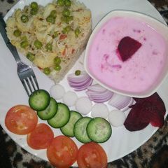 A picture of Vegetable pulao with beetroot raita.