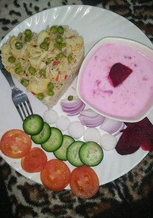 A picture of Vegetable pulao with beetroot raita.
