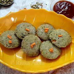 A picture of Green Moong daal and Rice idlis.