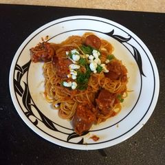 A picture of Sun dried tomatoes with angel hair pasta.