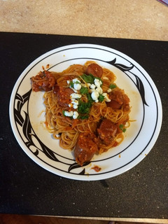 A picture of Sun dried tomatoes with angel hair pasta.