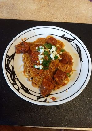 A picture of Sun dried tomatoes with angel hair pasta.