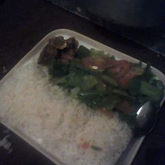 A picture of White rice green salad and beef.
