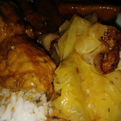 A picture of Smothered pork chops, yams and cabbage w/ bacon.