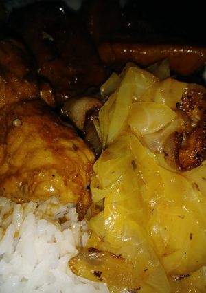 A picture of Smothered pork chops, yams and cabbage w/ bacon.