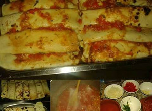 Una foto de Canelones de acelga con salsa roja