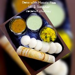 A picture of Dosa with masala aloo,idli & sambhar,coconut Chutney.