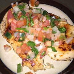 A picture of Homemade Pico De Gallo over Chicken.