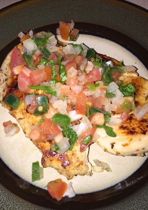 A picture of Homemade Pico De Gallo over Chicken.