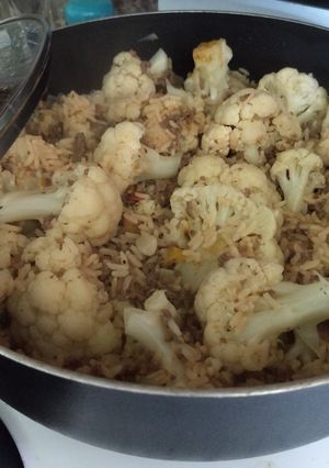 A picture of Dirty rice covered in cauliflower.