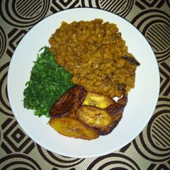 A picture of Porridge Beans With Fried Plantain and steamed Spinach.