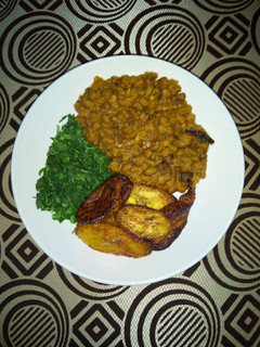 A picture of Porridge Beans With Fried Plantain and steamed Spinach.