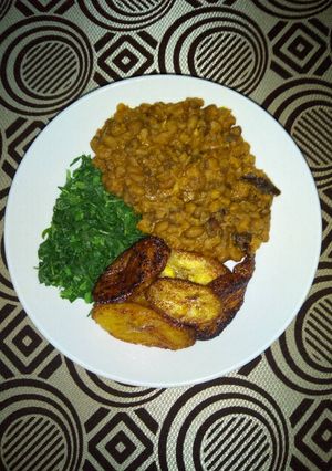 A picture of Porridge Beans With Fried Plantain and steamed Spinach.