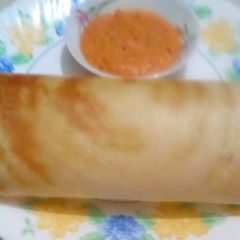 A picture of Paper roast dosa with tomato chutney.