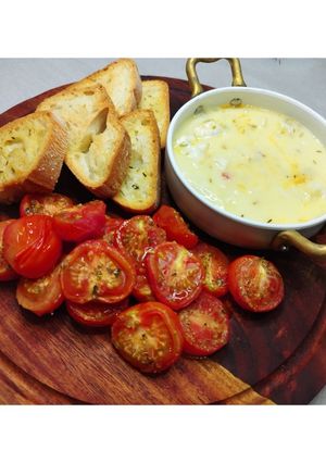 A picture of Baked Camembert with Confit Tomatoes and Garlic Bruschetta.