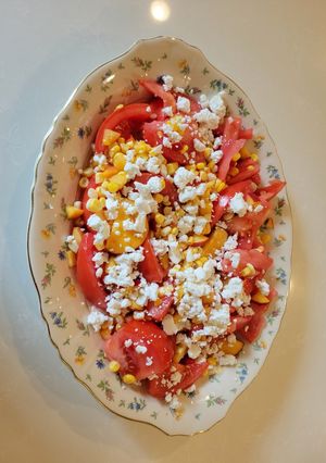 A picture of Tomato, peach and corn salad.