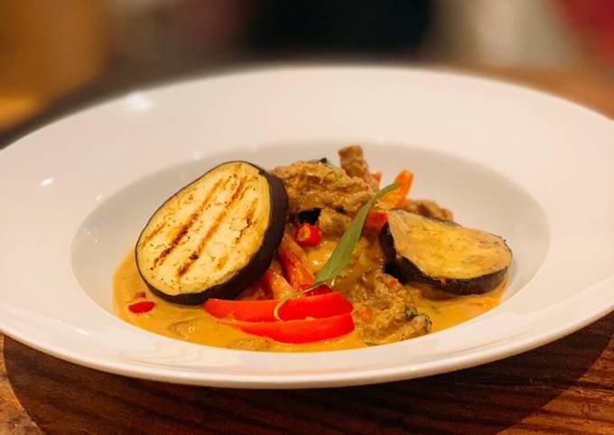 Beef and grilled aubergine red curry topped with Bird eye chillis
