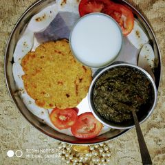 A picture of Sarso ka saag or makki ki roti with taazi chaajh.