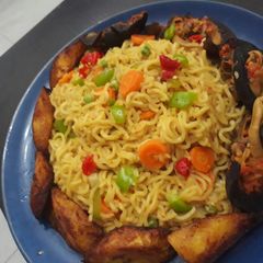 Indomine with fried plantain,snails and vegetables A picture of Indomine with fried plantain,snails and vegetables.