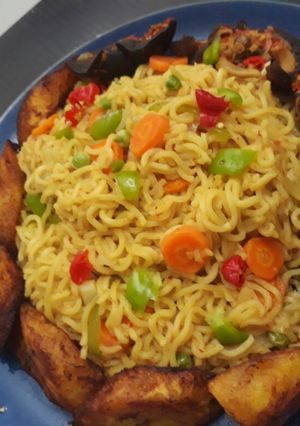 A picture of Indomine with fried plantain,snails and vegetables.