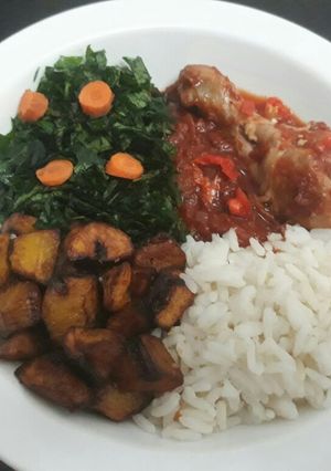 A picture of Rice,Fried plantain with vegetable and tomatoe stew.
