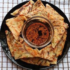 A picture of Korean Pancake With Dipping Sauce.