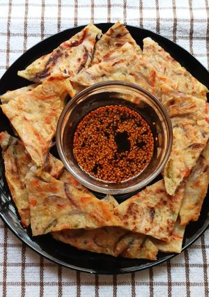 A picture of Korean Pancake With Dipping Sauce.