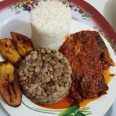 A picture of White Rice, Beans, Plantain and Cat Fish Stew.