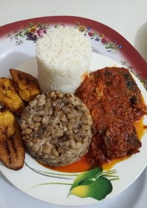 A picture of White Rice, Beans, Plantain and Cat Fish Stew.