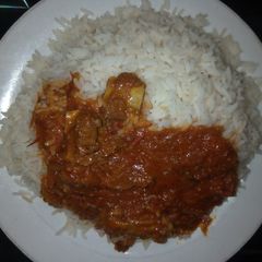 A picture of White rice with beef stew.
