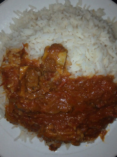 A picture of White rice with beef stew.