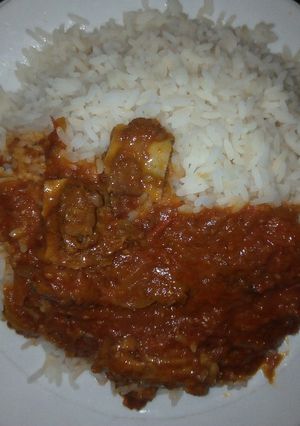 A picture of White rice with beef stew.