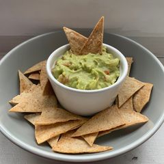 A picture of Tortilla chips with guacamole.