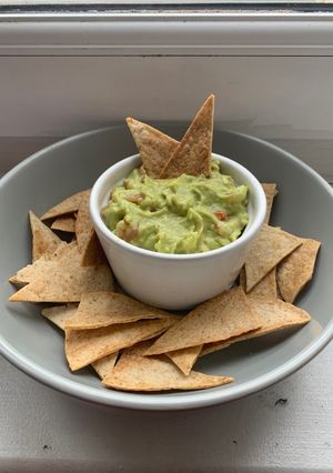 A picture of Tortilla chips with guacamole.