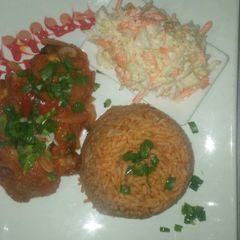 Jollof rice,coleslaw and chicken A picture of Jollof rice,coleslaw and chicken.
