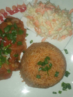 A picture of Jollof rice,coleslaw and chicken.