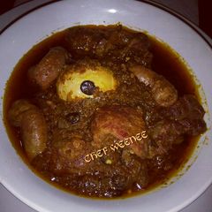 A picture of Ofada Sauce with Assorted meat.