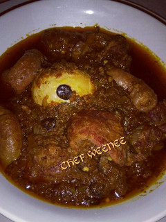 A picture of Ofada Sauce with Assorted meat.