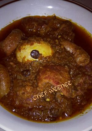 A picture of Ofada Sauce with Assorted meat.