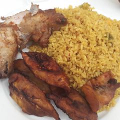 A picture of Curry rice,fried plantain and chicken.