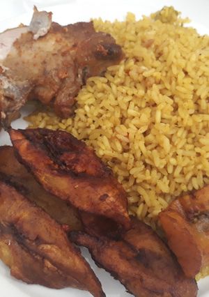 A picture of Curry rice,fried plantain and chicken.