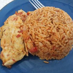 A picture of Jollof rice and fried egg.