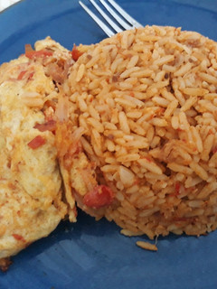 A picture of Jollof rice and fried egg.