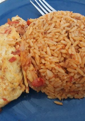 A picture of Jollof rice and fried egg.