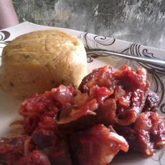 A picture of Fresh Corn pudding paired with Asun (peppered roasted goat meat.