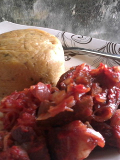 A picture of Fresh Corn pudding paired with Asun (peppered roasted goat meat.