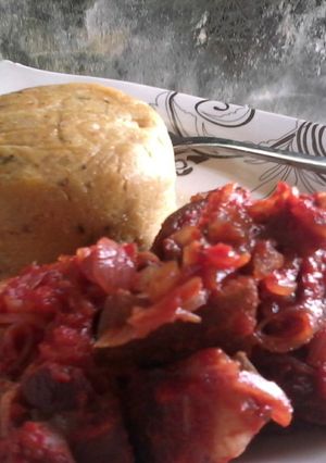 A picture of Fresh Corn pudding paired with Asun (peppered roasted goat meat.