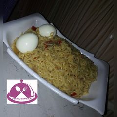 A picture of Noddles jollof with egg.