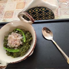 A picture of Sarson and Palak Creamy bhurji tempered with fried Onion.